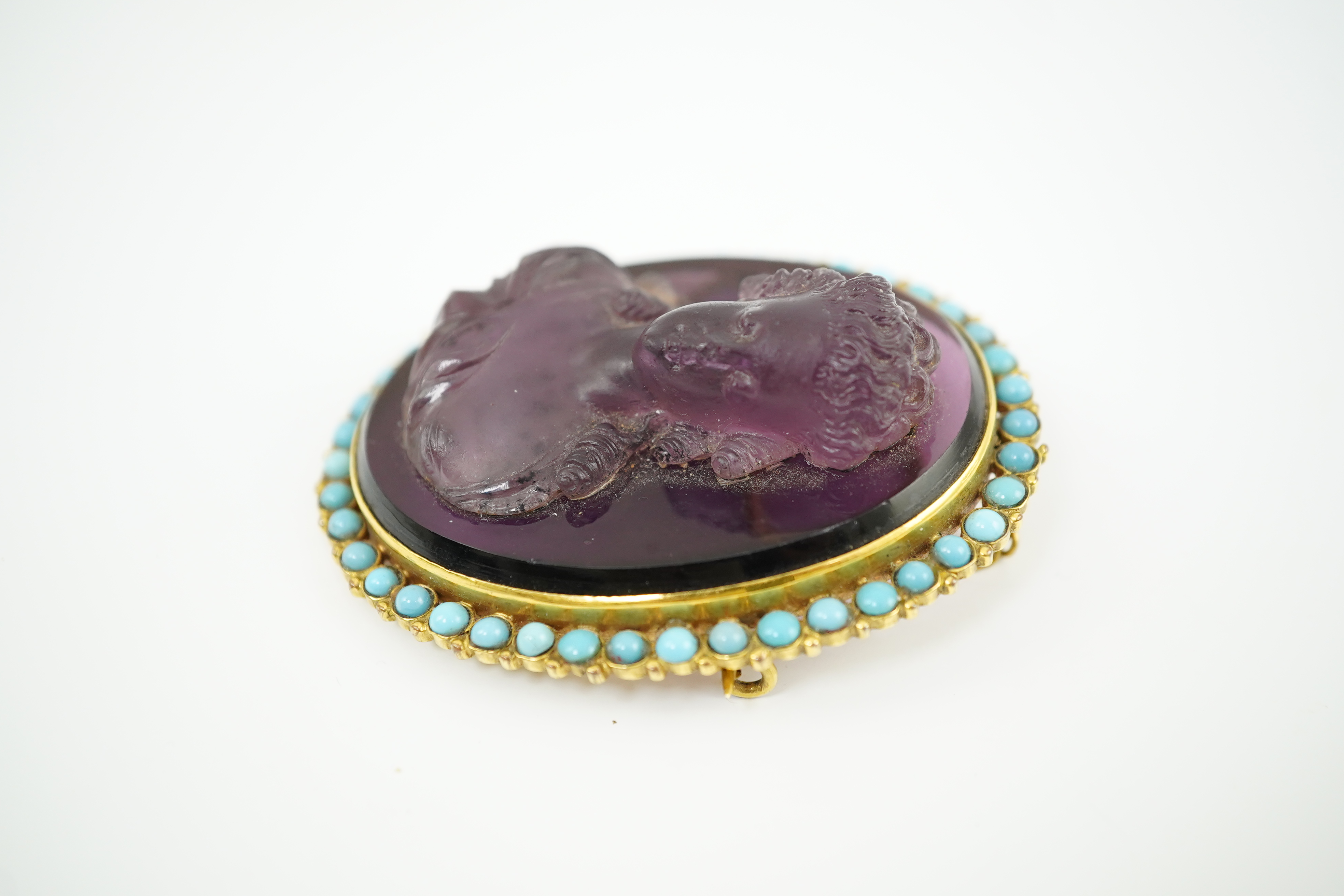 A late 19th/early 20th century gold and turquoise enamel? mounted oval amethyst paste set brooch